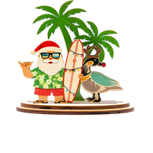 Load image into Gallery viewer, Hawaiian Santa Claus with a surfboard and a nene goose with reindeer antlers in front of palm trees
