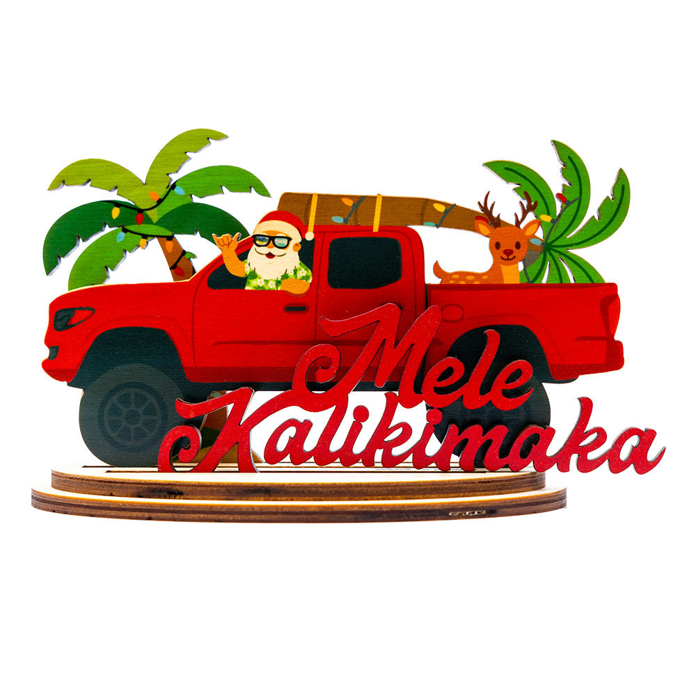 Decorative lifted red truck with Santa Claus, Rudolph and palm trees, featuring 'Mele Kalikimaka' script.