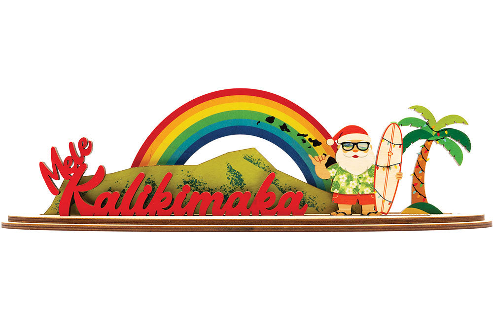 Decorative sign with a rainbow, palm tree, Diamond Head and tropical Santa Claus figure with 'Mele Kalikimaka' text.