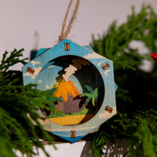 Load image into Gallery viewer, Decorative 3D ornament with a tropical scene hanging on a Christmas tree.
