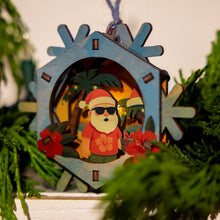 Load image into Gallery viewer, Decorative 3D Christmas ornament with a tropical Santa Claus design, surrounded by greenery and other ornaments.
