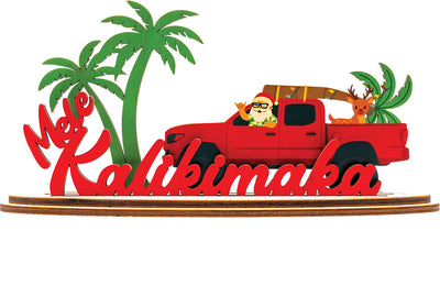 Decorative sign with a red truck, Santa Claus, and palm trees featuring 'Mele Kalikimaka' text.