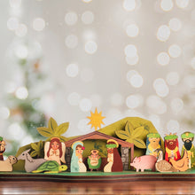 Load image into Gallery viewer, A wooden nativity scene set featuring cut-out letter shapes with figures of Mary, Joseph, and baby Jesus, along with other nativity characters, all crafted in a tropical theme with green and brown colors, in front of sparkle bokeh backdrop.
