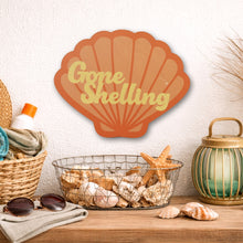 Load image into Gallery viewer, Decorative shell sign with 'Gone Shelling' text on a shelf with beach-themed items.
