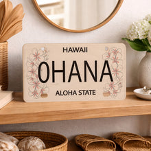 Load image into Gallery viewer, Decorative sign with 'Ohana and Aloha State' on a shelf with decorative items.
