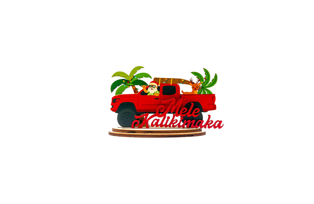 Decorative lifted red truck with Santa Claus, Rudolph and palm trees, featuring 'Mele Kalikimaka' script.