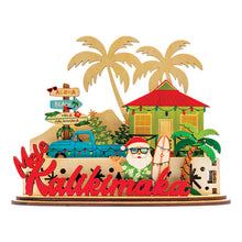 Load image into Gallery viewer, Decorative 3D holiday tiered sign with Santa holding a surfboard, a blue truck, beach shack and other tropical elements with &#39;Mele Kalikimaka&#39; script on a white background
