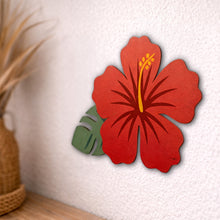 Load image into Gallery viewer, Red hibiscus flower wall decor on a textured white wall with a plant in the corner.
