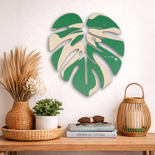 Load image into Gallery viewer, Decorative monstera leaf in green and white pattern with Hawaiian islands graphic hnaging on wall above console table
